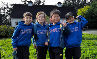 Four Grade 2 students pose for a photo at Sea Cider Farm