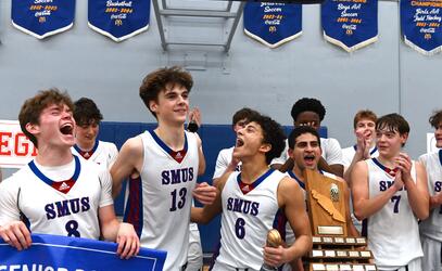 Senior Boys Basketball players celebrate together