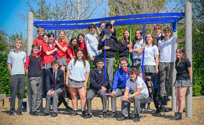 The Lifers Class of 2025 returns to the Junior School for a group photo on the playground.