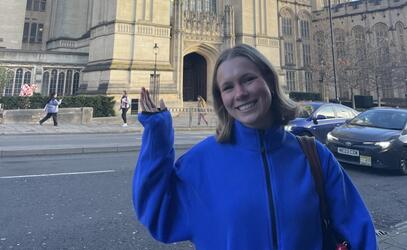 Harper May '24 poses in front of a historic building in Bristol, UK