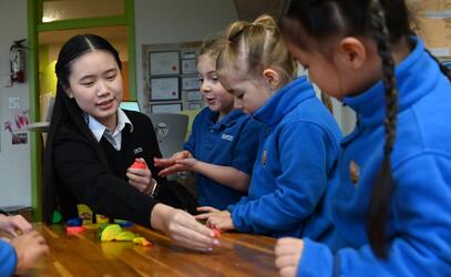 Grade 11 student Cindy Chen plays with JK students