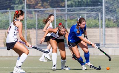 Mackenna Brown dribbles the field hockey ball in competition at the Friendship Cup