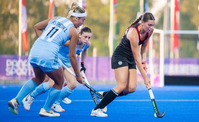 Wynn Brown '23 dribbles the ball in a field hockey game for team Canada