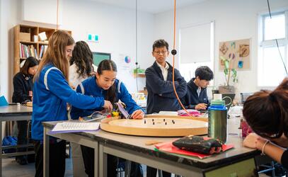 Grade 9 Engineering students test their crokinole machines