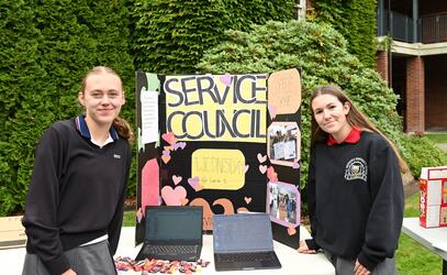 Service Council heads Lucy Turnbull and Bianca Batoni pose with their service council sign and table