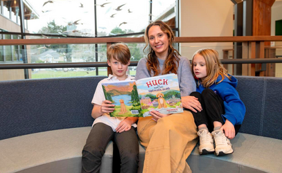 The Lindenmuth family with the book they wrote, Huck the Roof Dog Vancouver Island