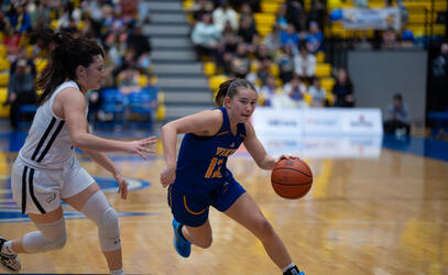 Avery Geddes dribbles up the court playing for the UVic Vikes