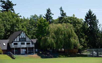 A large willow tree beside the Wenman Pavilion on a sunny day