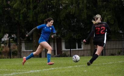 Senior Girls Soccer Manon Denux dribbles against a Claremont player 