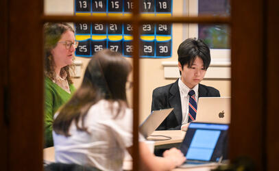 Students engage on their laptops in a classroom