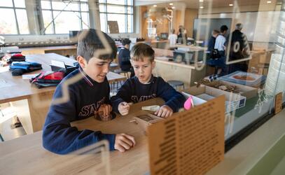 Two students collaborate in the ADST lab of the Considine Annex