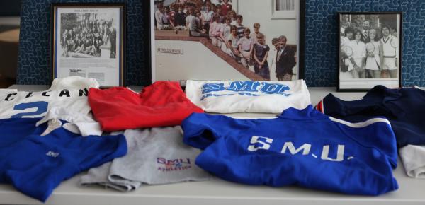 A table with memorabilia from the first intake of girls to SMUS