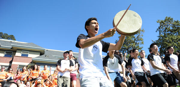 Bolton house boarders doing a cheer with a drum