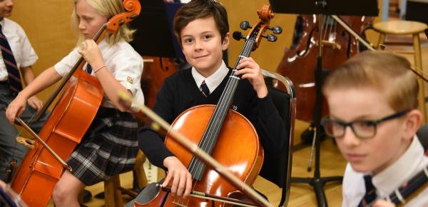 Middle School strings students playing the cello