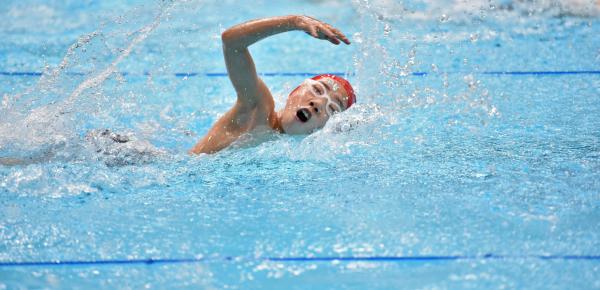 Middle School student participating in a swim jamboree