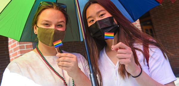 Students showing the pride flag and colours