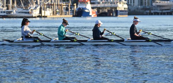 Senior School 4 person rowing shell in the Inner Harbour