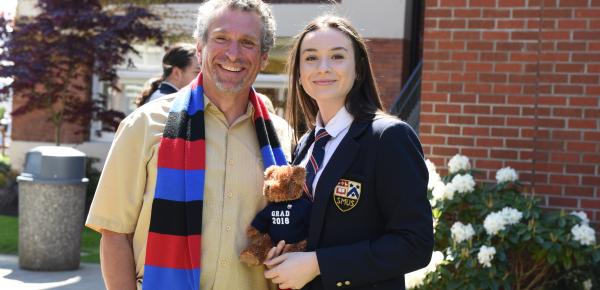 Alumni and SMUS graduate with a grad bear