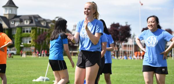 Happy students playing house games in the field