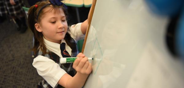 Junior School student working on a whiteboard