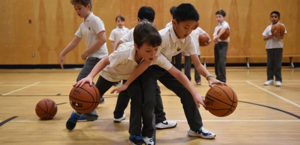 Junior School students playing basketball in the gym