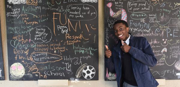 Senior School student in front of blackboards with writings about school spirit