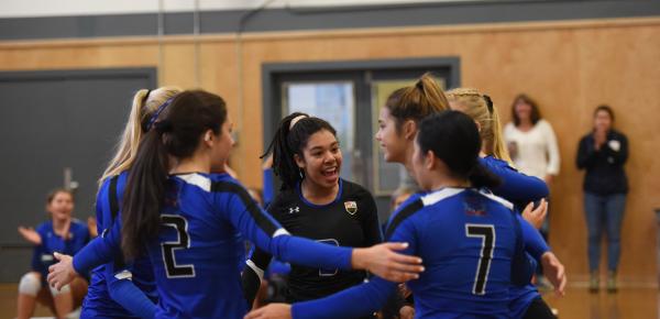 Senior girls volleyball team in a huddle