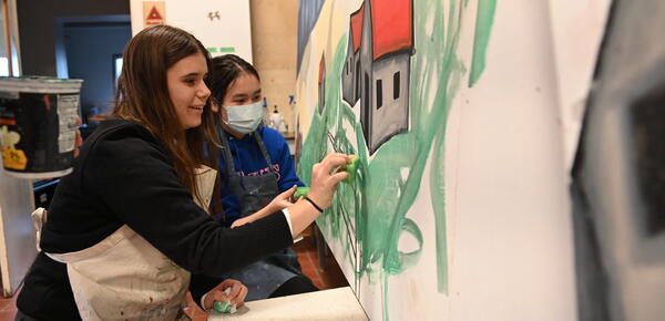 Students painting in art studio