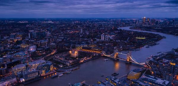 The skyline of London, England at twilight, taken over the Thames.