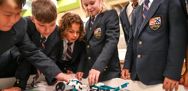 Junior School Grade 5 students play with lego robots in the iLab