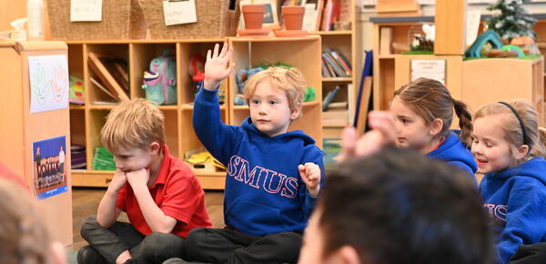 Kindergarten student raises their hand