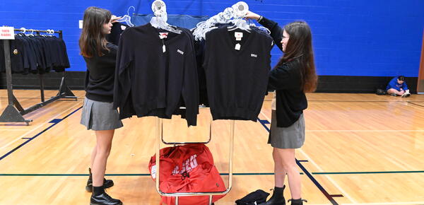 Students are picking out the uniform cardigans