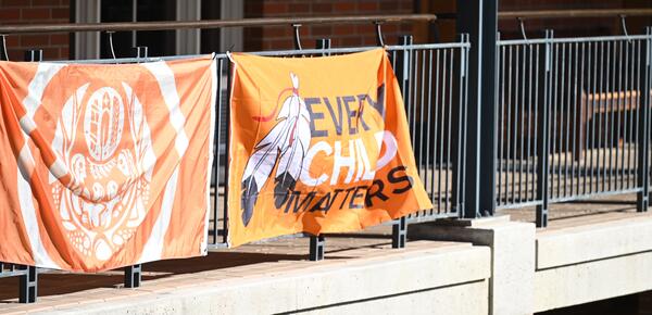 NDTR Orange Shirt Day Flags hang on the Crothall balcony.
