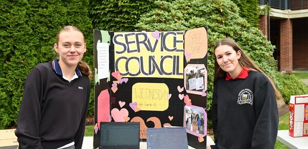 Service Council heads Lucy Turnbull and Bianca Batoni pose with their service council sign and table