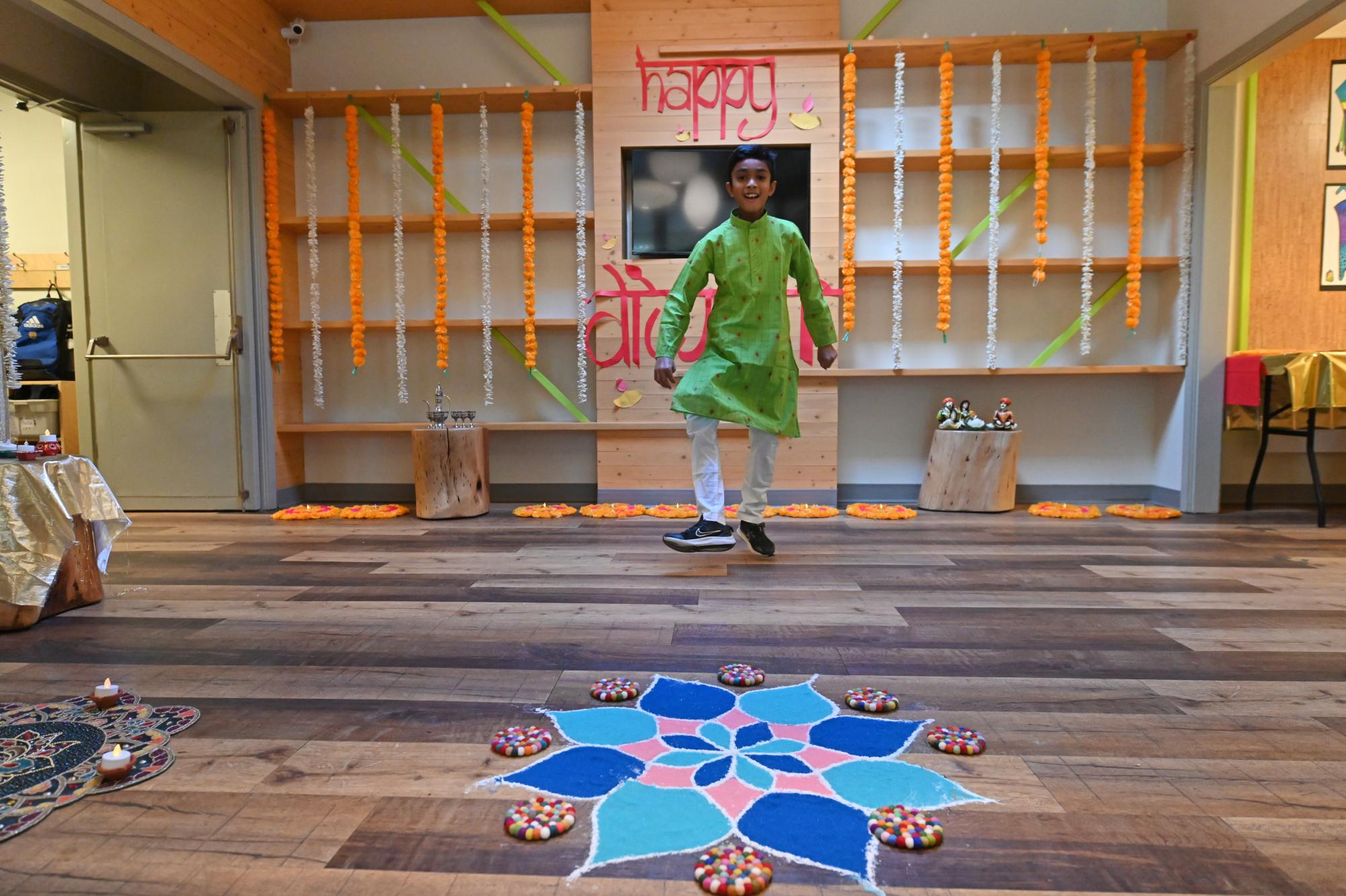 A student performs a dance in the foyer of the Junior School while celebrating Diwali