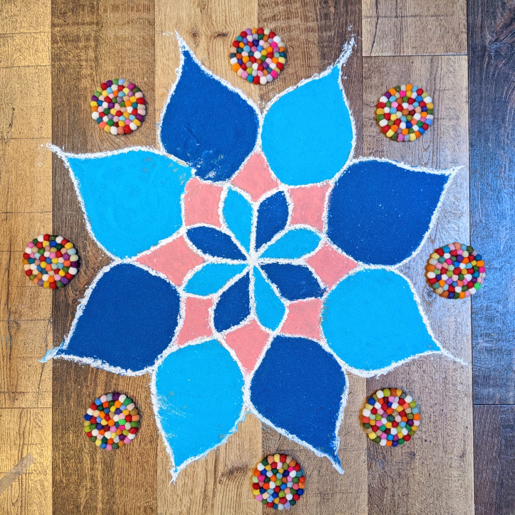 A beautifully designed rangoli made of sand on the floor of the Junior School