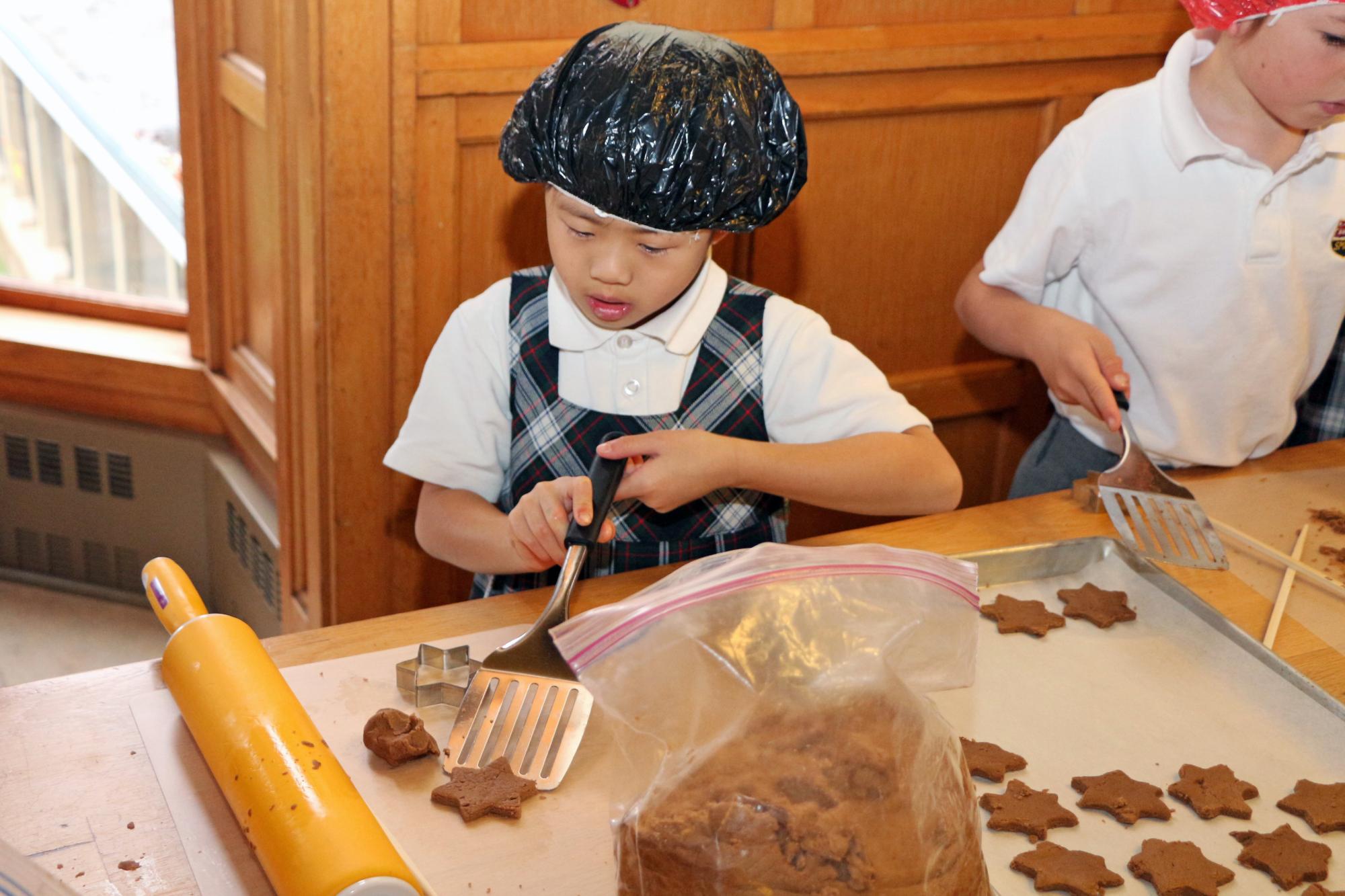 A Grade 2 student focuses on making gingerbread cookies