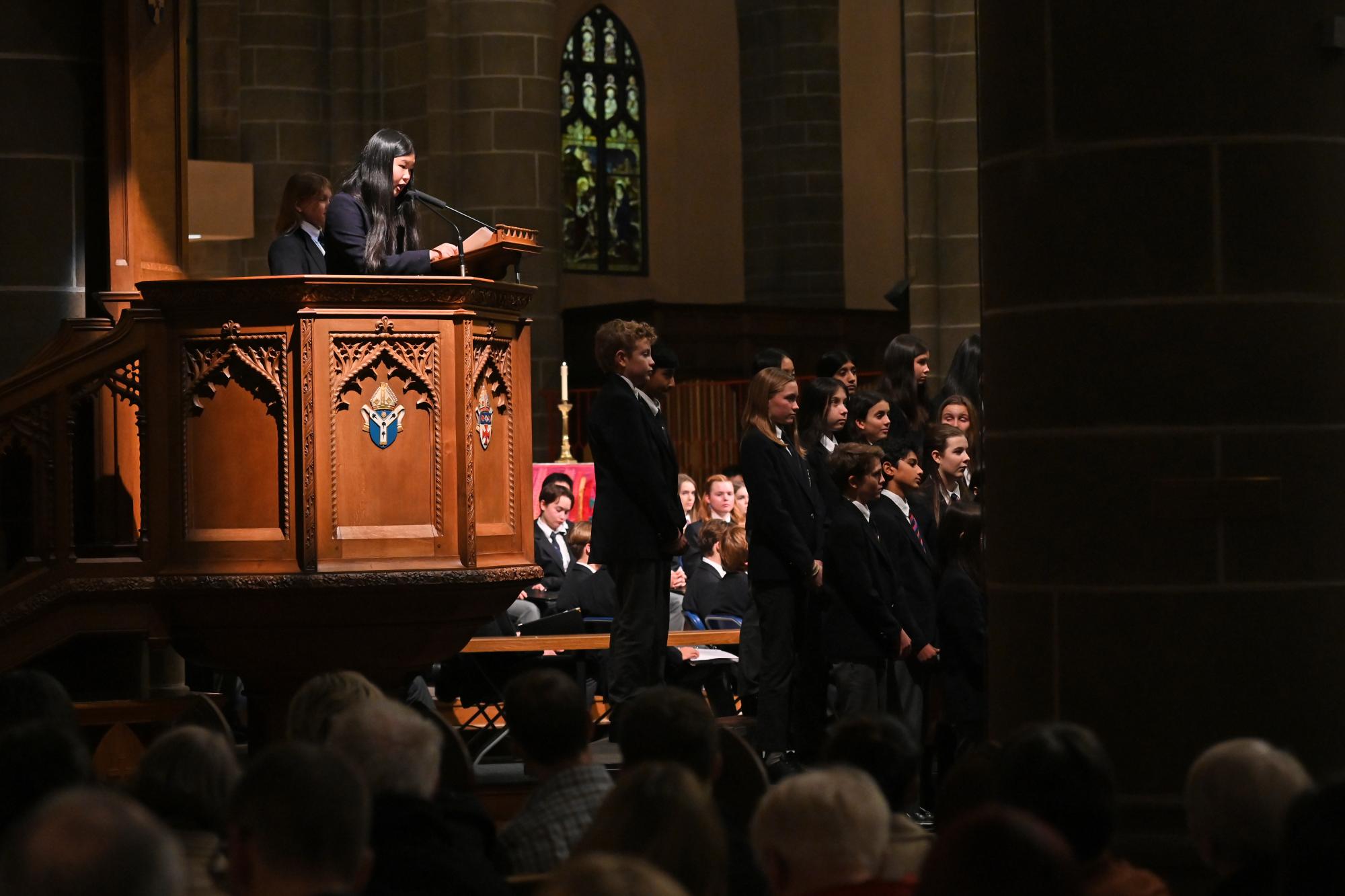 A Middle School student reads a reflection during the Carol Service at Christ Church Cathedral