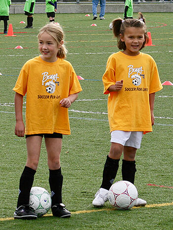 Two young girls at soccer practice