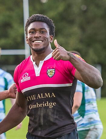 A photo of Dave Duru giving the thumbs up on the rugby field