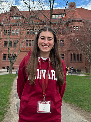 Ilona stands outside a building at Harvard University