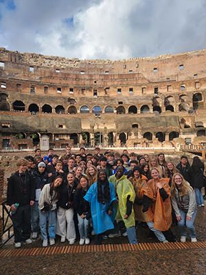 Students pose inside the Colosseum in Rome