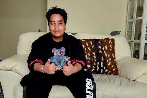 BSYE Contestant Marc Njenga gives a thumbs up from his couch at home.