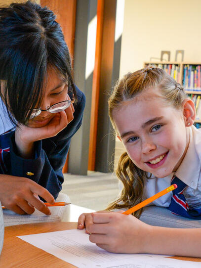 Two Junior School students work on a project together
