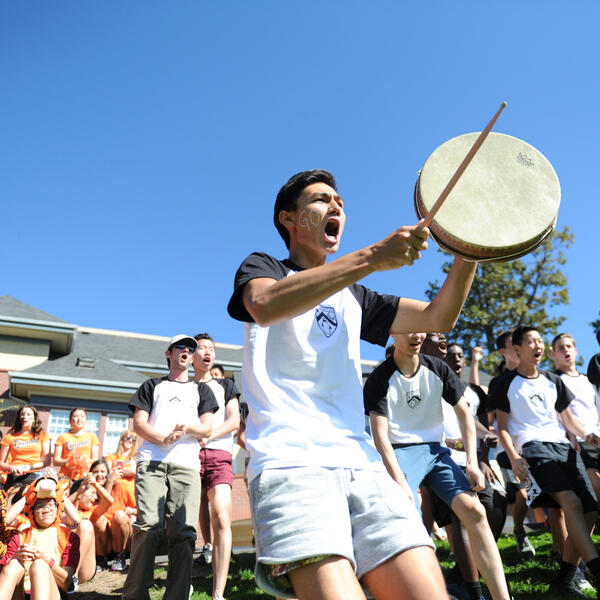 Bolton house boarders doing a cheer with a drum