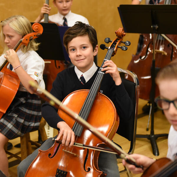 Middle School strings students playing the cello