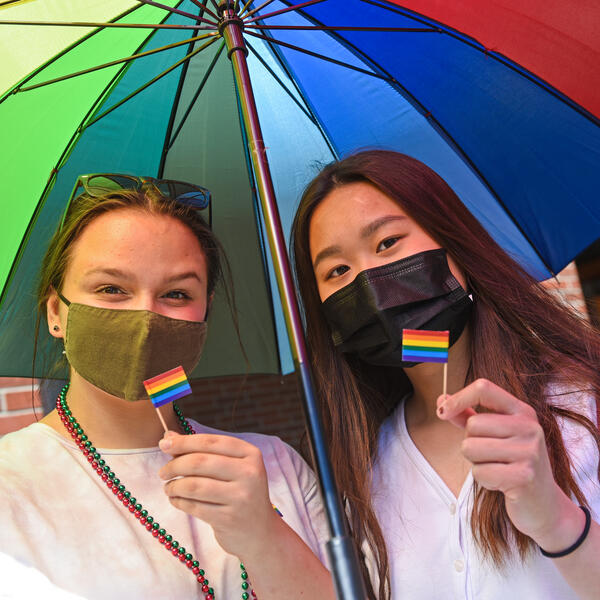 Students showing the pride flag and colours