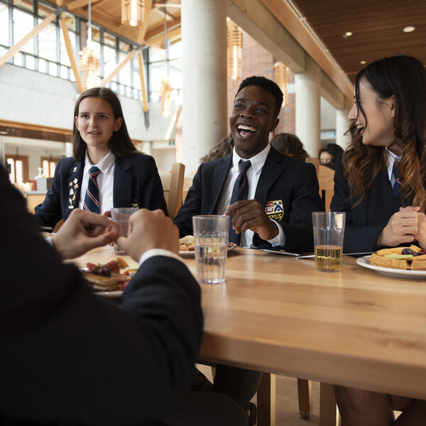 Senior School friends sharing a meal in the dining hall