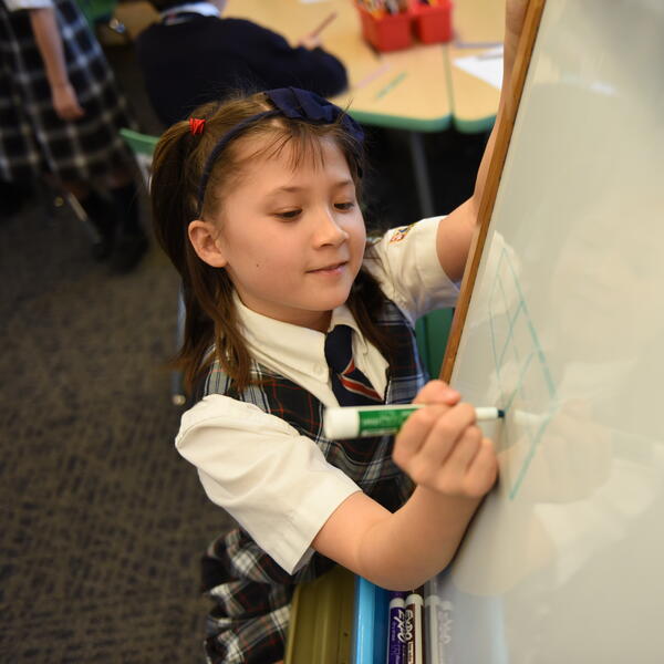 Junior School student working on a whiteboard