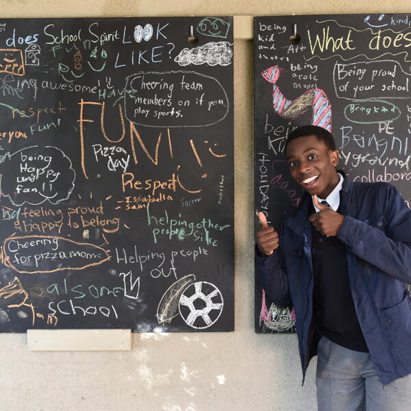Senior School student in front of blackboards with writings about school spirit